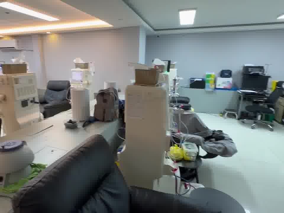 The treatment floor between sessions: dialysis machines and reclining chairs.